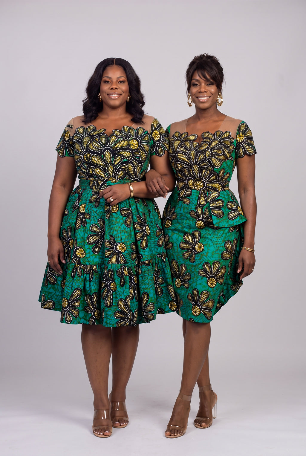 Plus size model in the Teal Flora African print skater dress standing with a regular model in the Teal Flora Ankara peplum dress