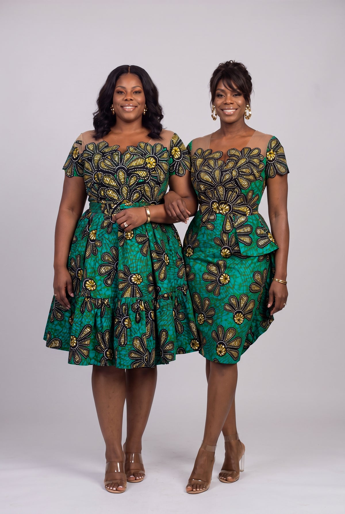 Plus size model in the Teal Flora African print skater dress standing with a regular model in the Teal Flora Ankara peplum dress