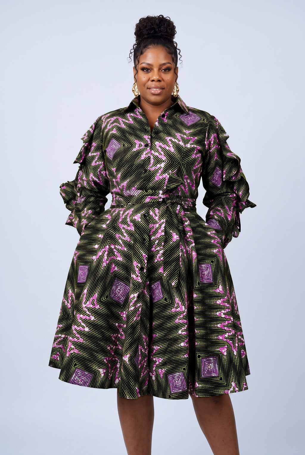 Half-length front view of green African print shirt dress with ruffle sleeves