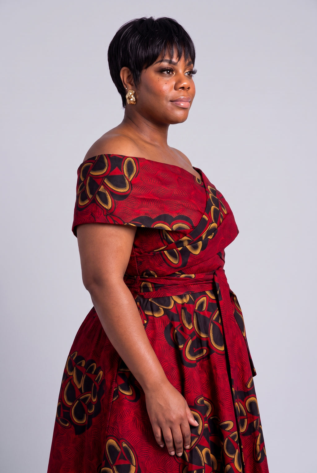 Detail view of red gold and charcoal Ankara wax print fabric