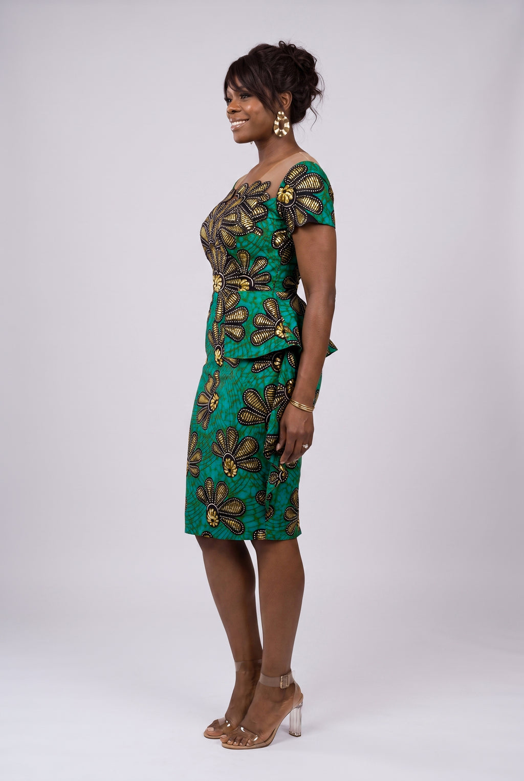 Side view of teal gold and black Ankara peplum midi dress