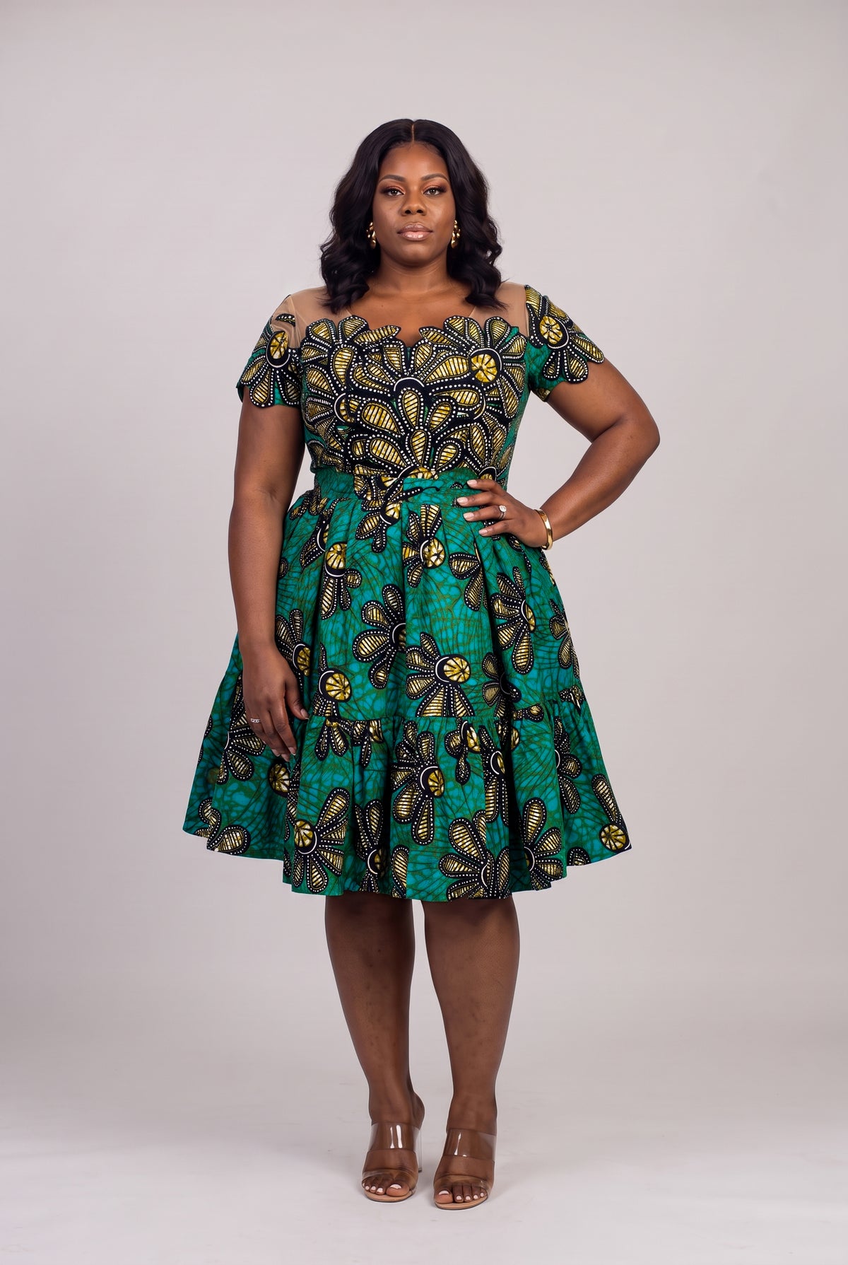 Plus size model wearing Teal Flora Ankara wedding guest dress