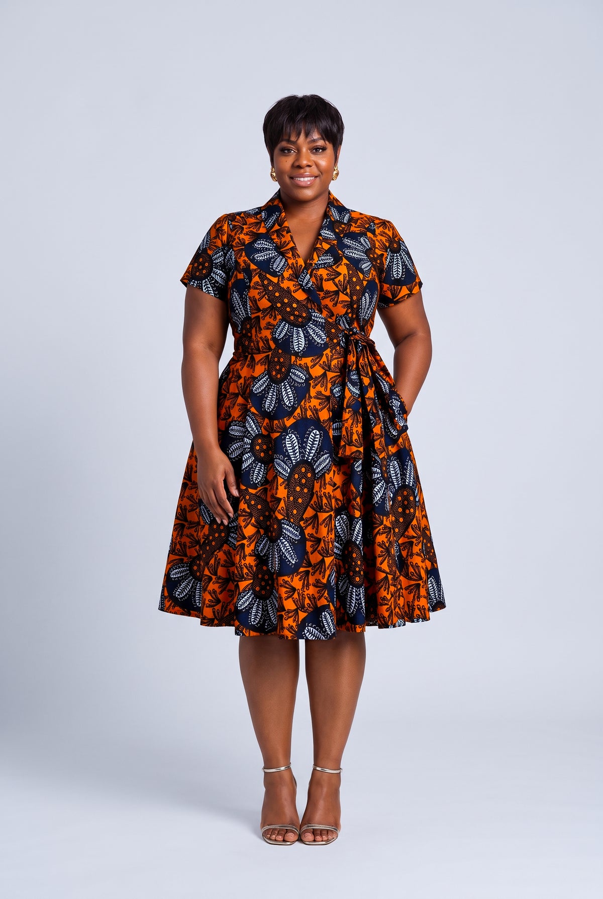 Front view plus size model wearing Marigold Bloom African wrap dress