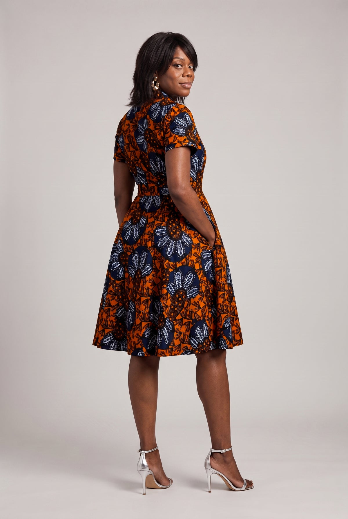 Back view of African wrap dress with tie waist detail and pockets 