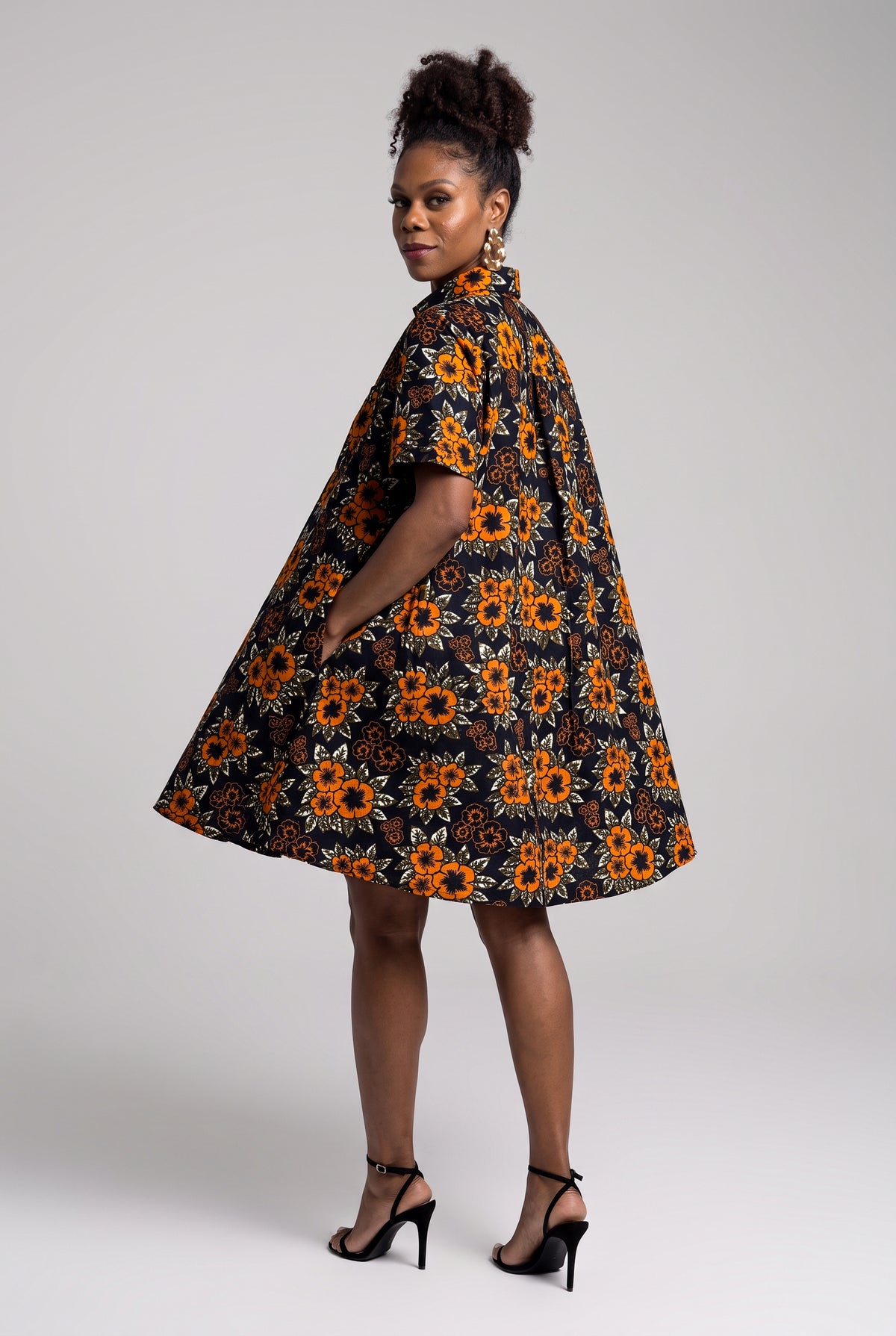 Back view of orange African print midi shirt dress
