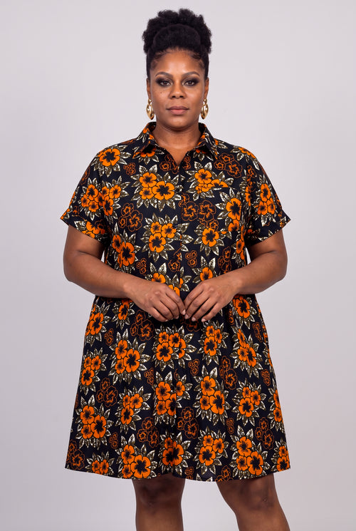 Plus size model wearing Amber Bloom Ankara shirt dress