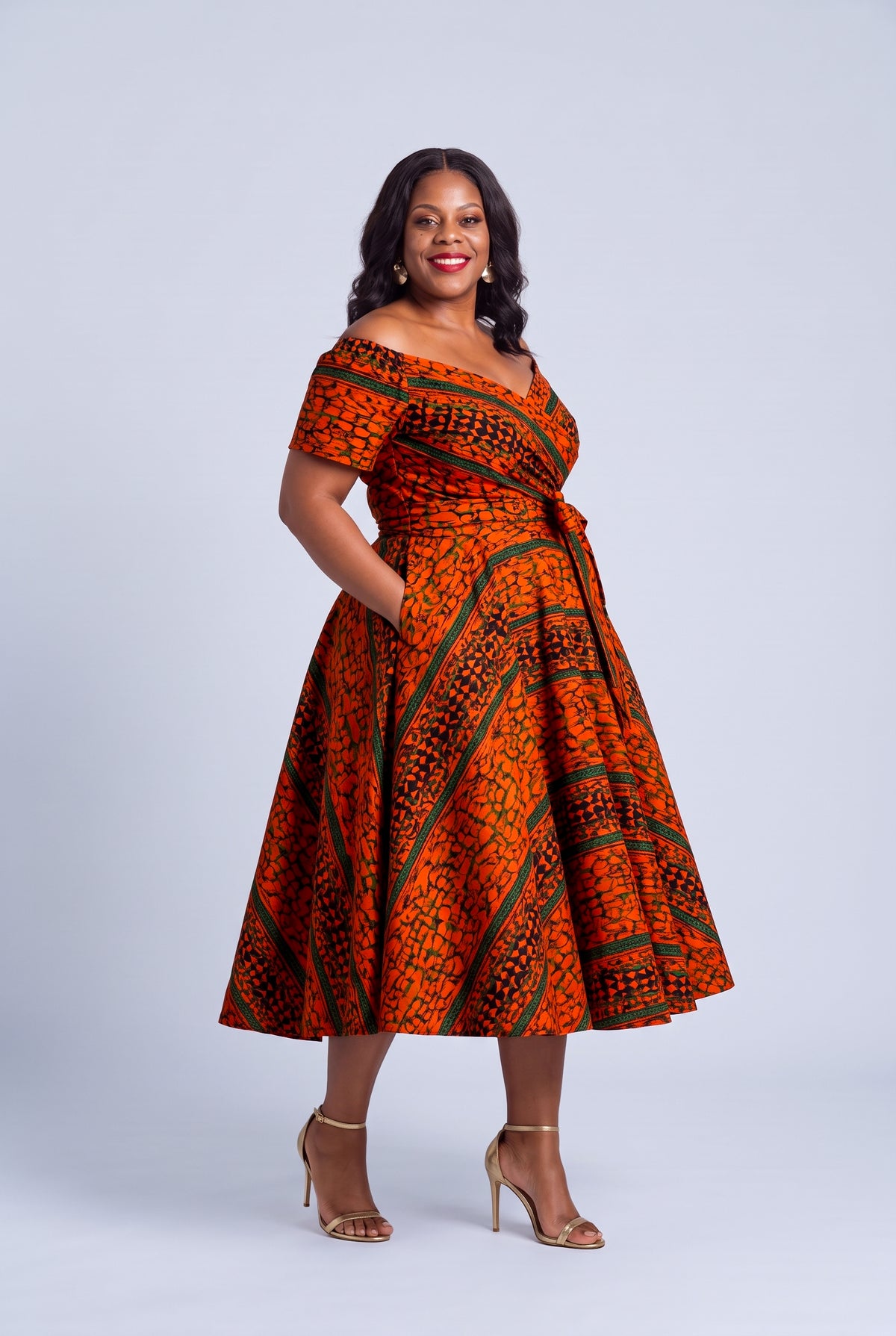  Side view of Amber Horizon orange green and navy Ankara off shoulder dress