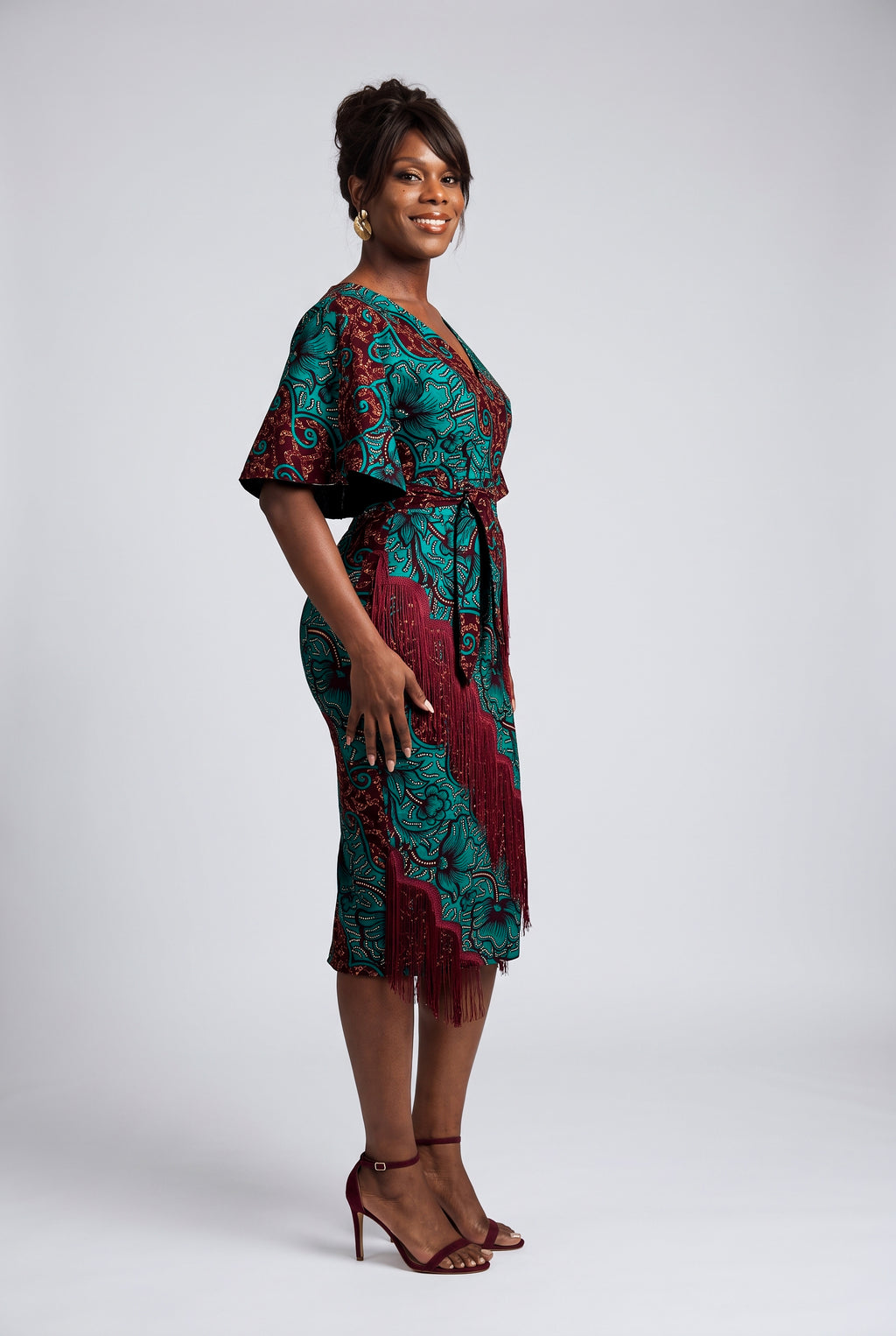 Side view of burgundy teal and gold Ankara midi dress