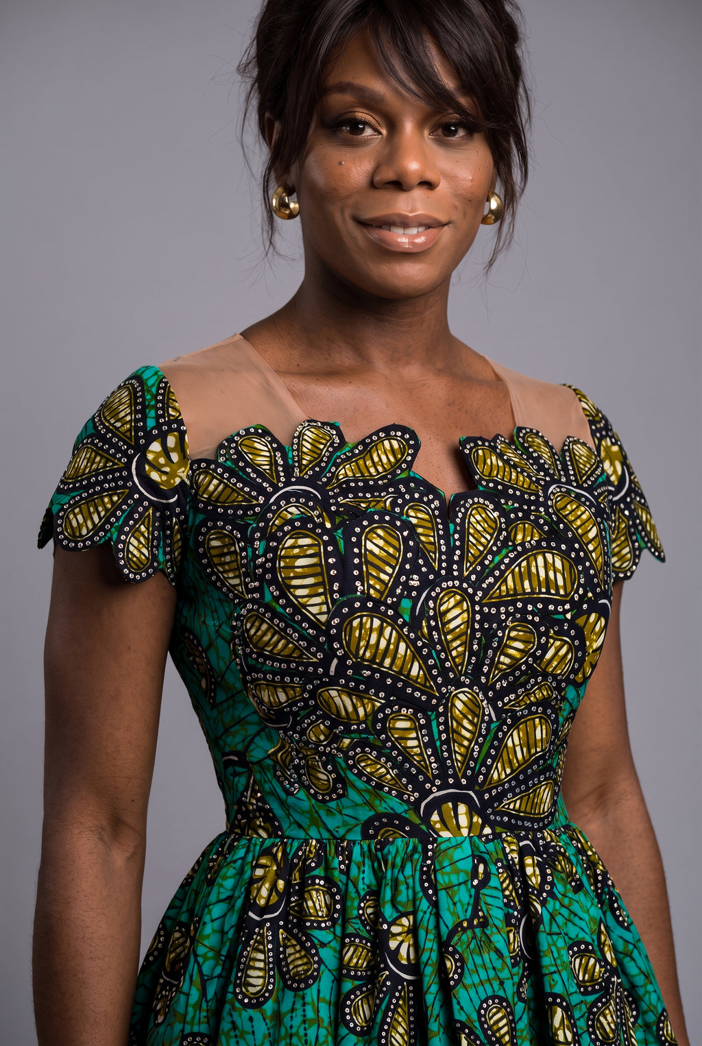 Detail view of teal gold and black Ankara wax print fabric