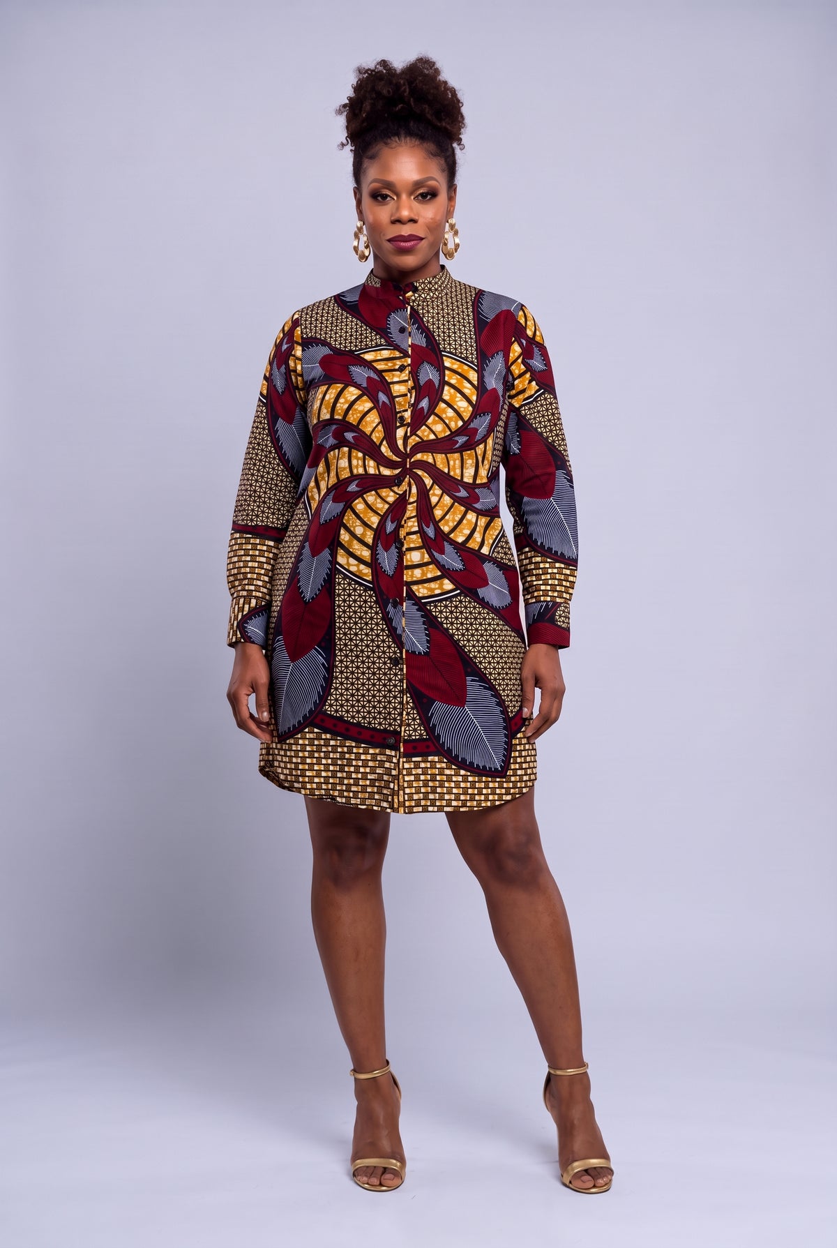 Model wearing Burgundy Helix burgundy and gold Ankara long sleeve shirt dress