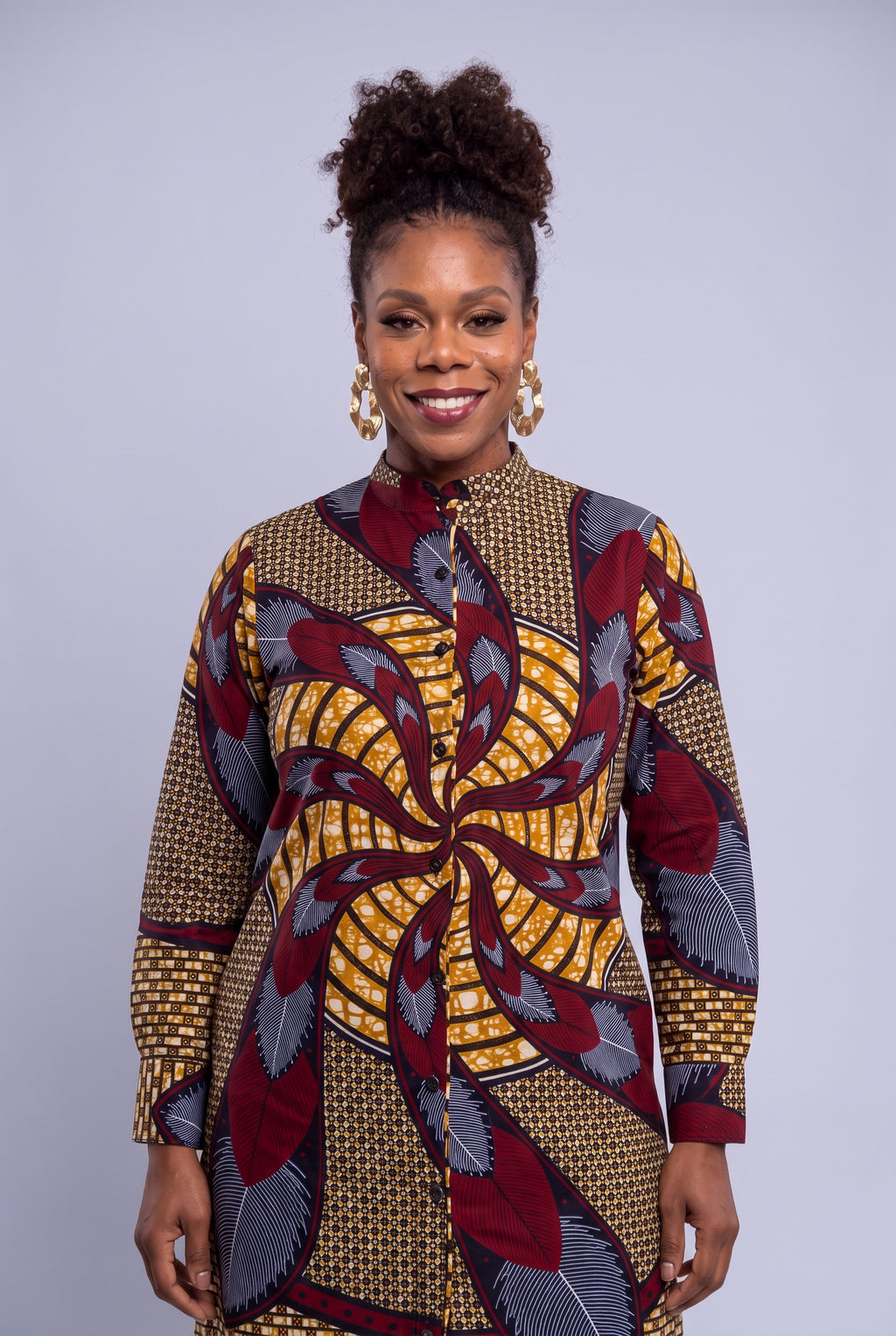 Close up font view of Burgundy Helix Ankara shirt dress with stand collar, buttons and burgundy leaf print