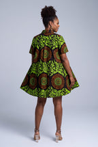 Back view of Lime Orbit Ankara swing shirt dress with lime green botanical and orange circular print
