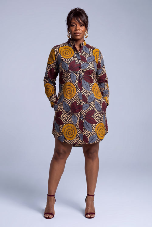 Model wearing Ochre Grove African print shirt dress with hands in the functional pockets