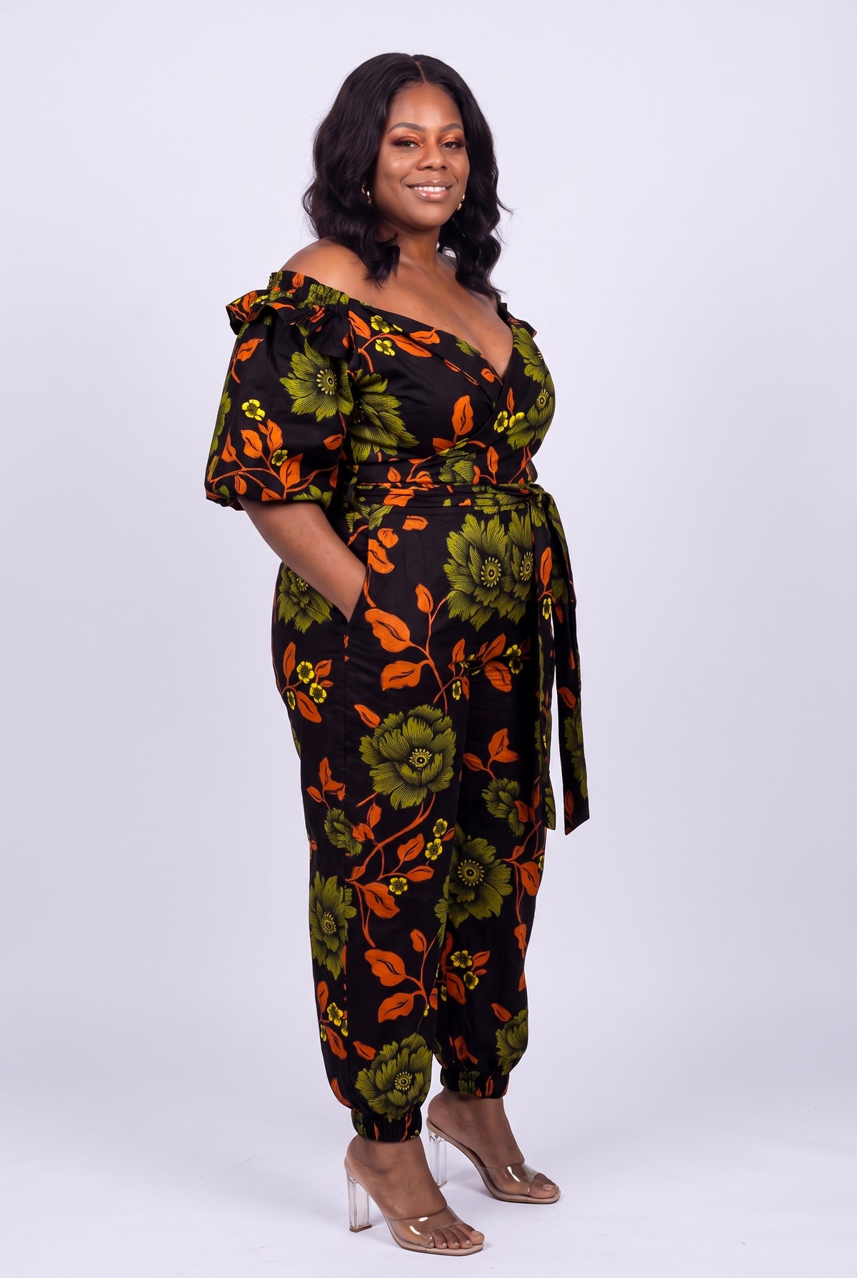 Side view of green and orange Ankara wrap top and trouser set