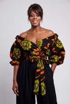 Close up shot of a crossover sweetheart neckline with a subtle ruffle trim on an olive green Ankara blouse