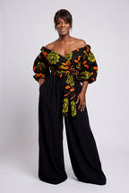 Full length view of Olive Oasis African print wrap top paired with flowing black palazzo trousers