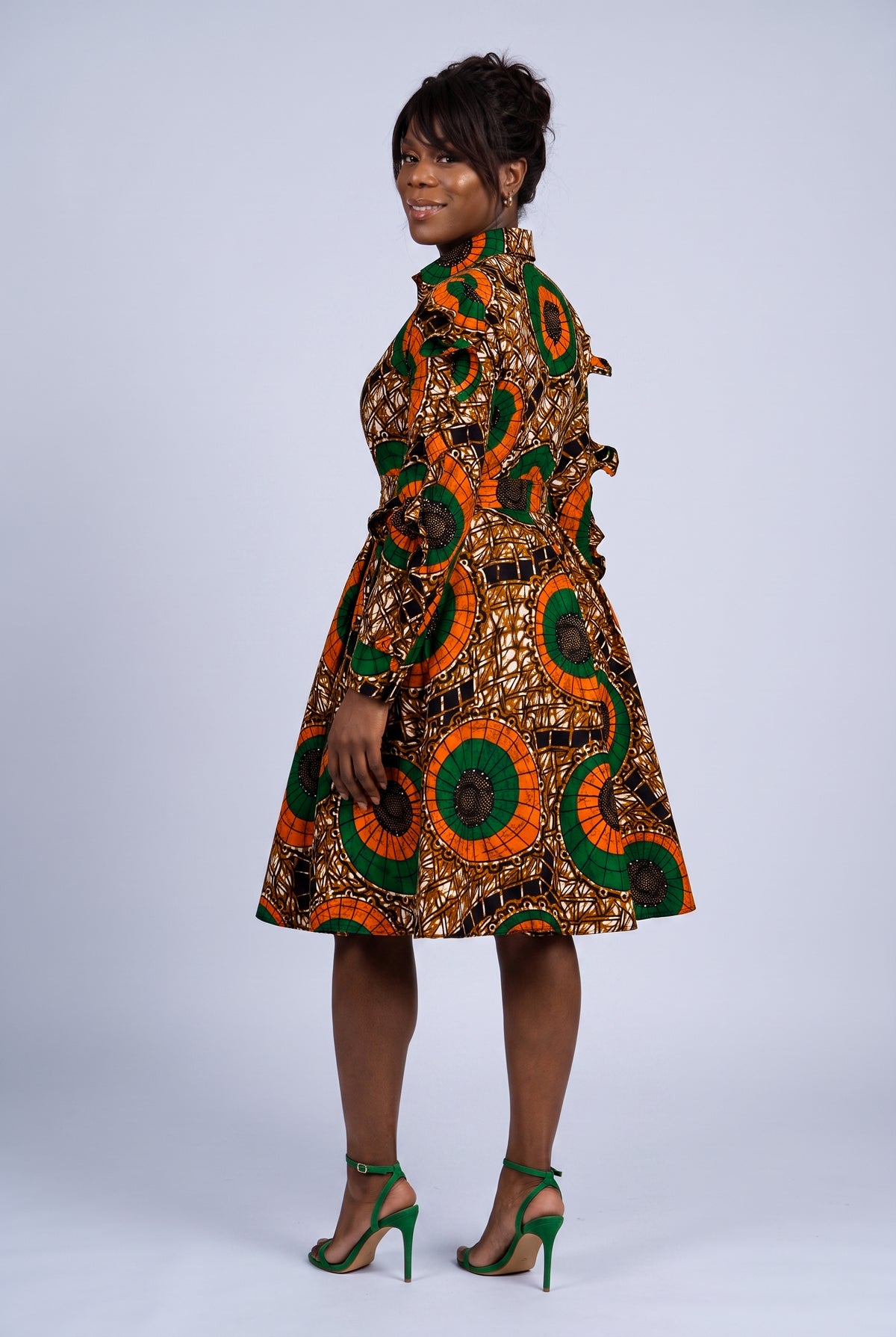 Back view of orange African print shirt dress with full circle skirt