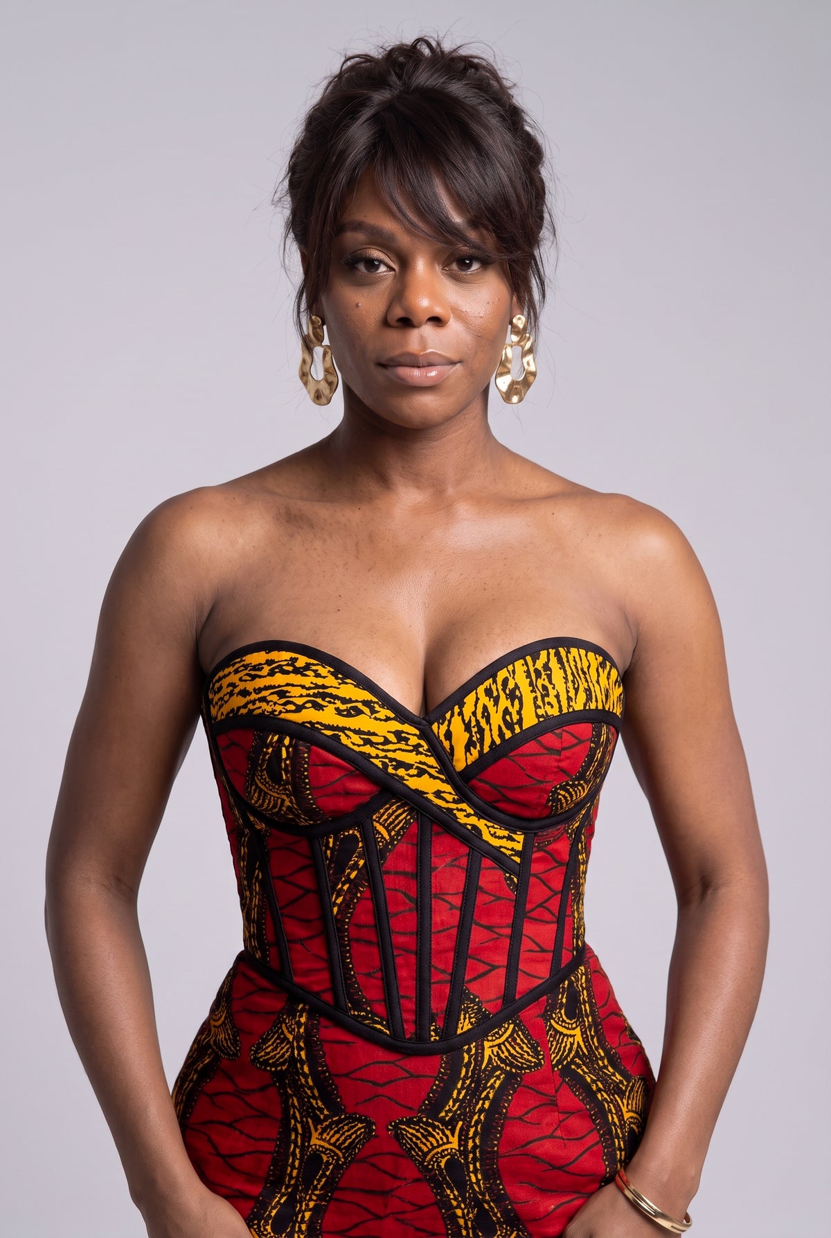 Close up of structured geometric grid pattern in red and gold strapless sweetheart corset Ankara dress 