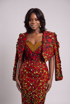 A detailed shot of a woman styling a red leaf print structured blazer jacket over a matching pencil dress layout as  2 piece African set