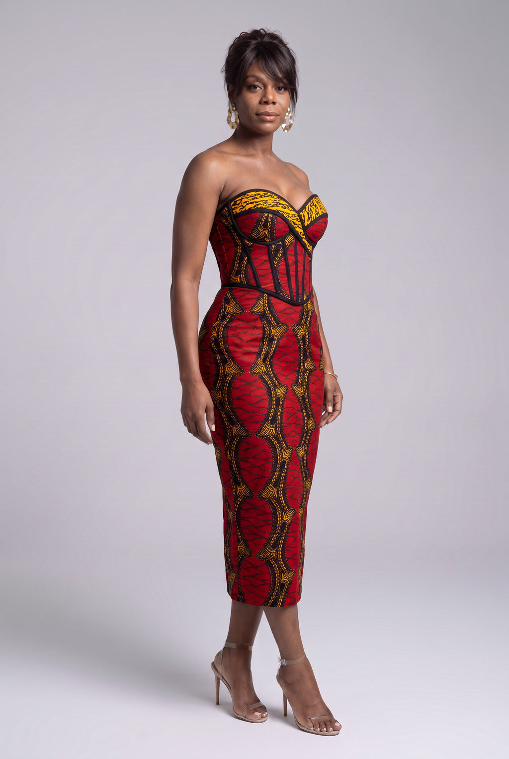 Side view of Red Grid red gold and black Ankara corset dress