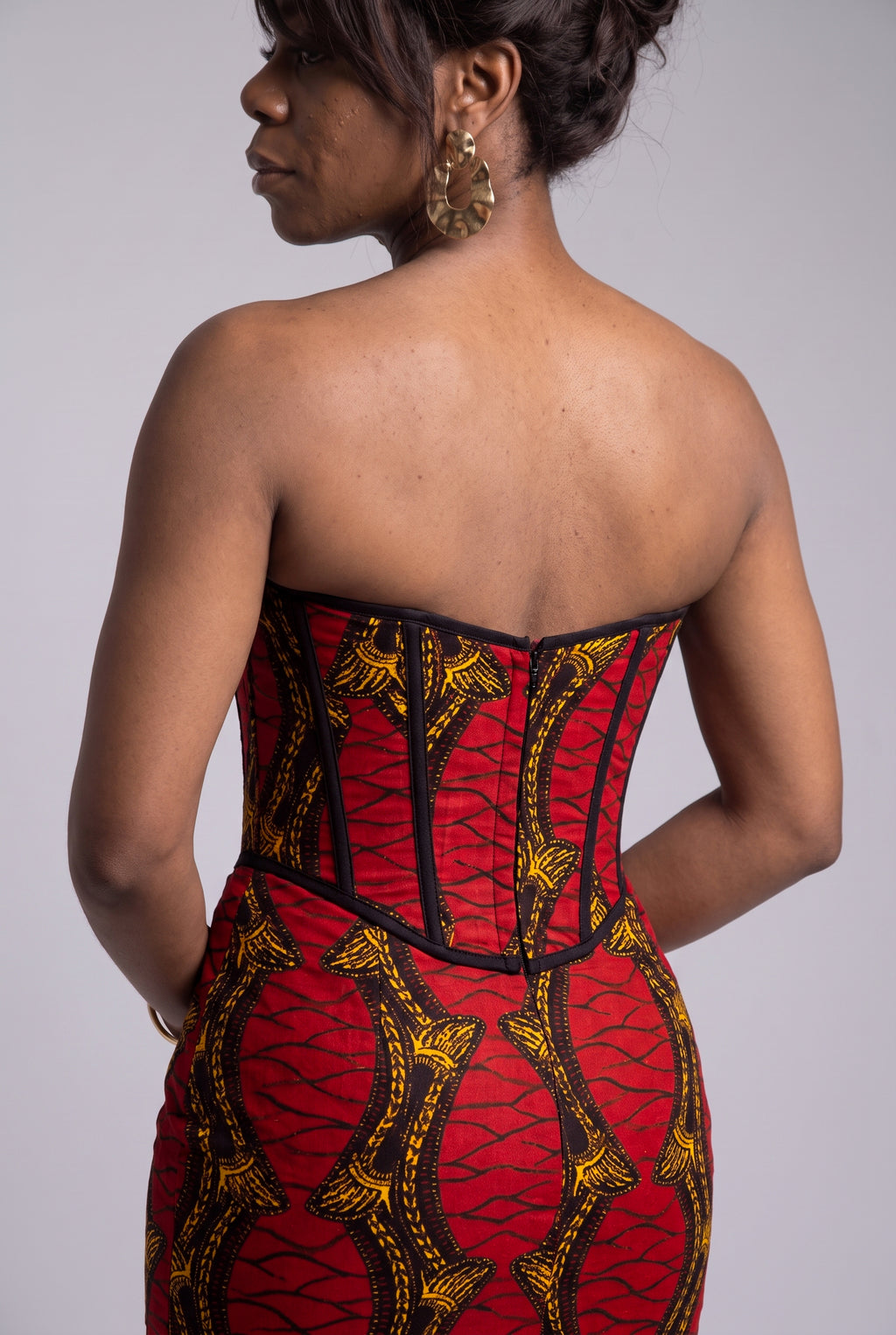 Close up back view of the red gold and black geometric Ankara wax print on the Red Grid dress