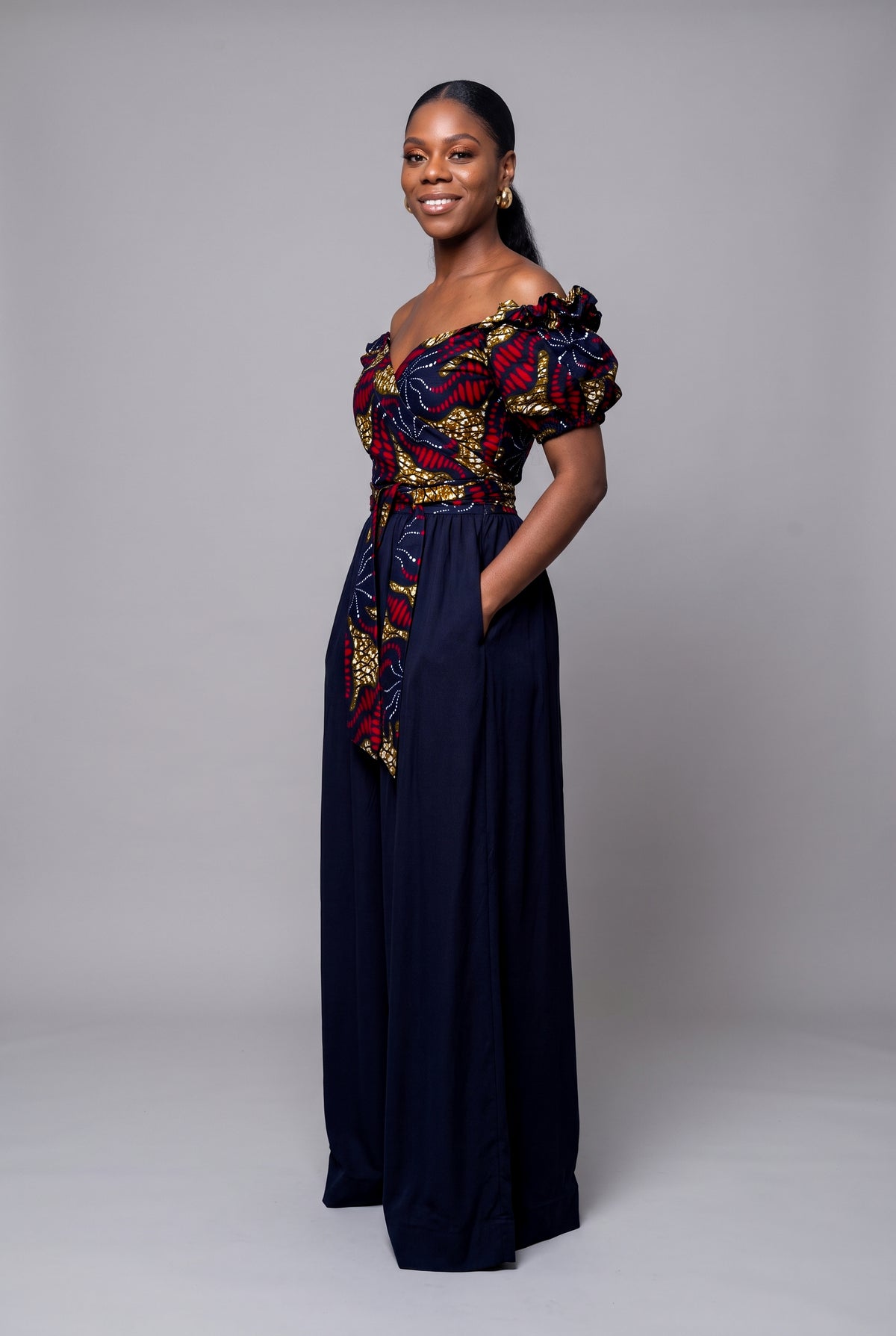 Three quarter view of Ruby Nova African print wrap top with solid Navy palazzo trouser