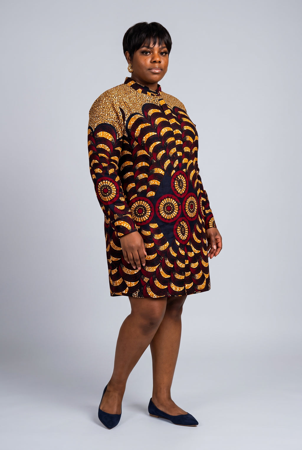 Three quarter view of Saffron Halo gold Ankara shirt dress with burgundy and navy circular motifs