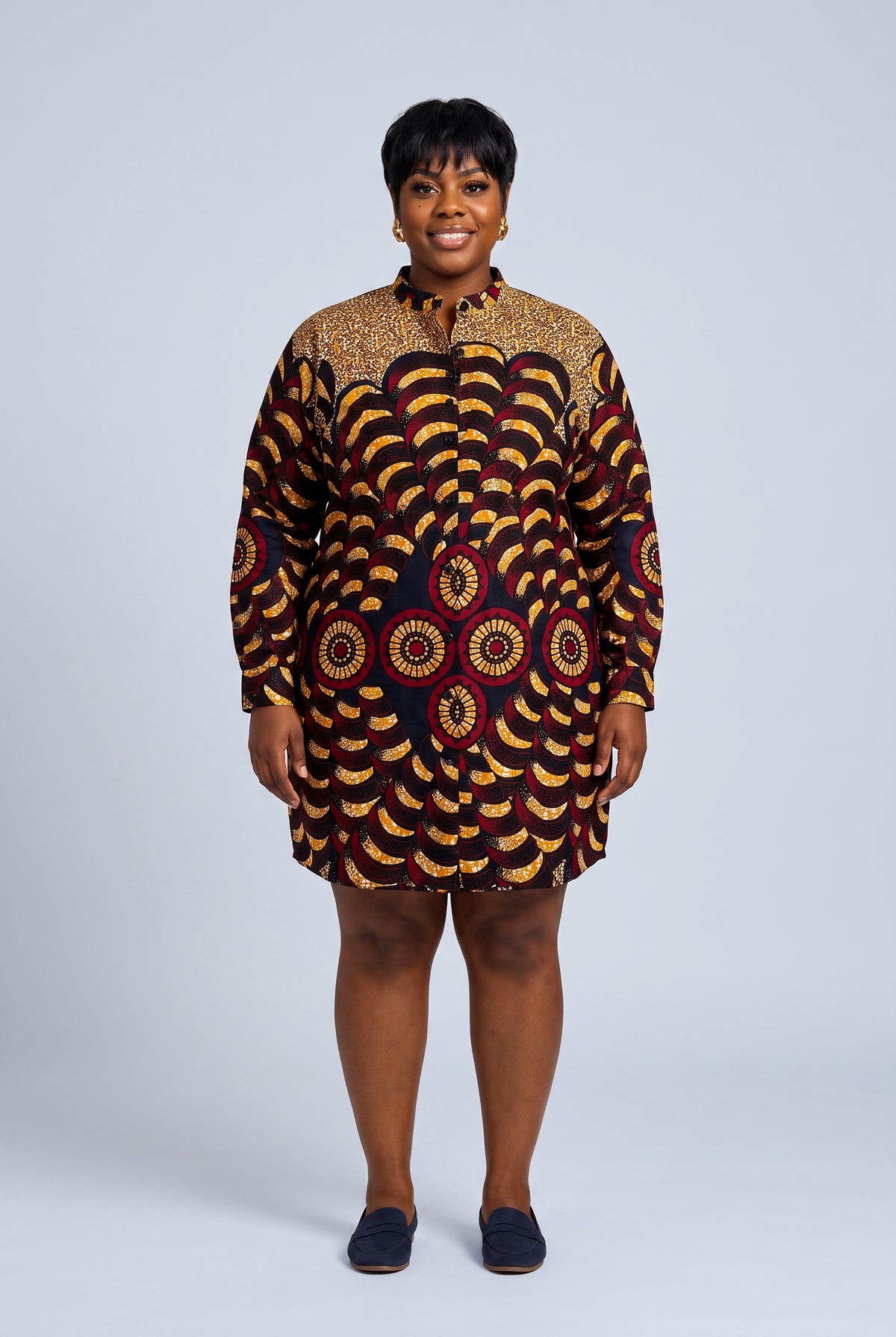 Plus size model wearing Saffron Halo gold and burgundy long sleeve Ankara dress with a relaxed above-knee fit