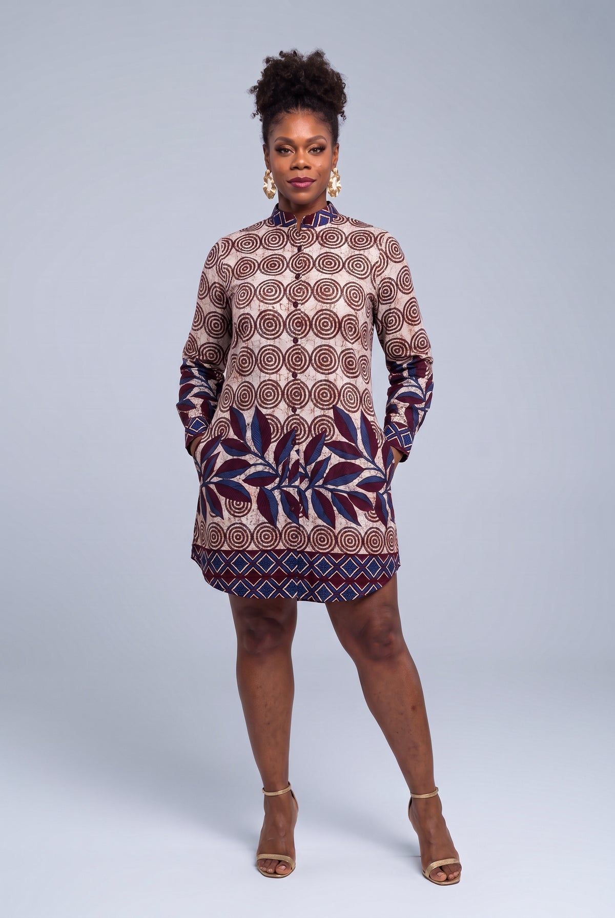 Front view of Spiral Vine African print shirt dress with hands in the side pockets