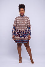 Model wearing Spiral Vine cream Ankara long sleeve shirt dress with burgundy and navy print