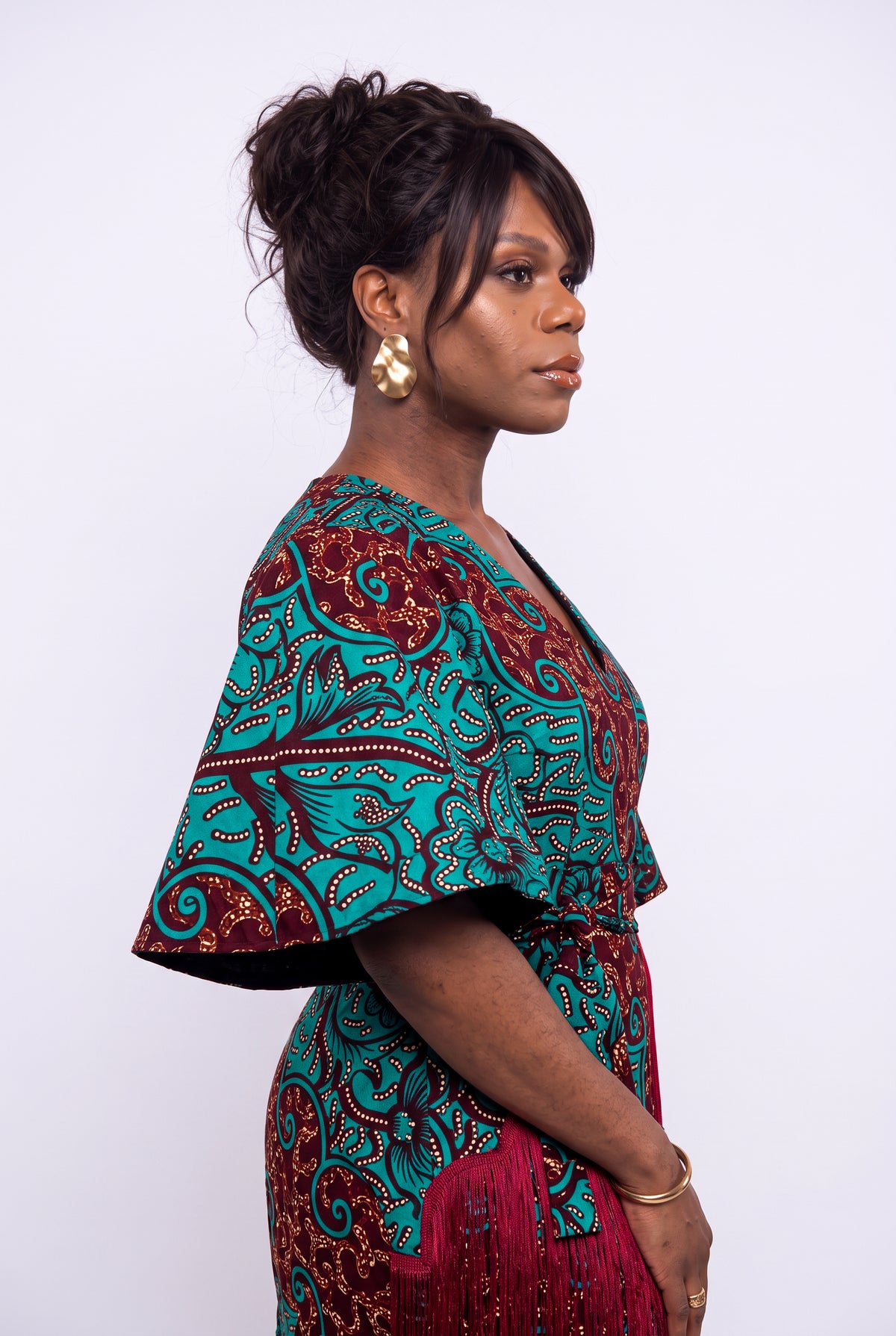 Teal and Burgundy Ankara dress side profile  studio portrait of a  model 