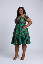 Side view of teal green gold and black Ankara wedding guest dress