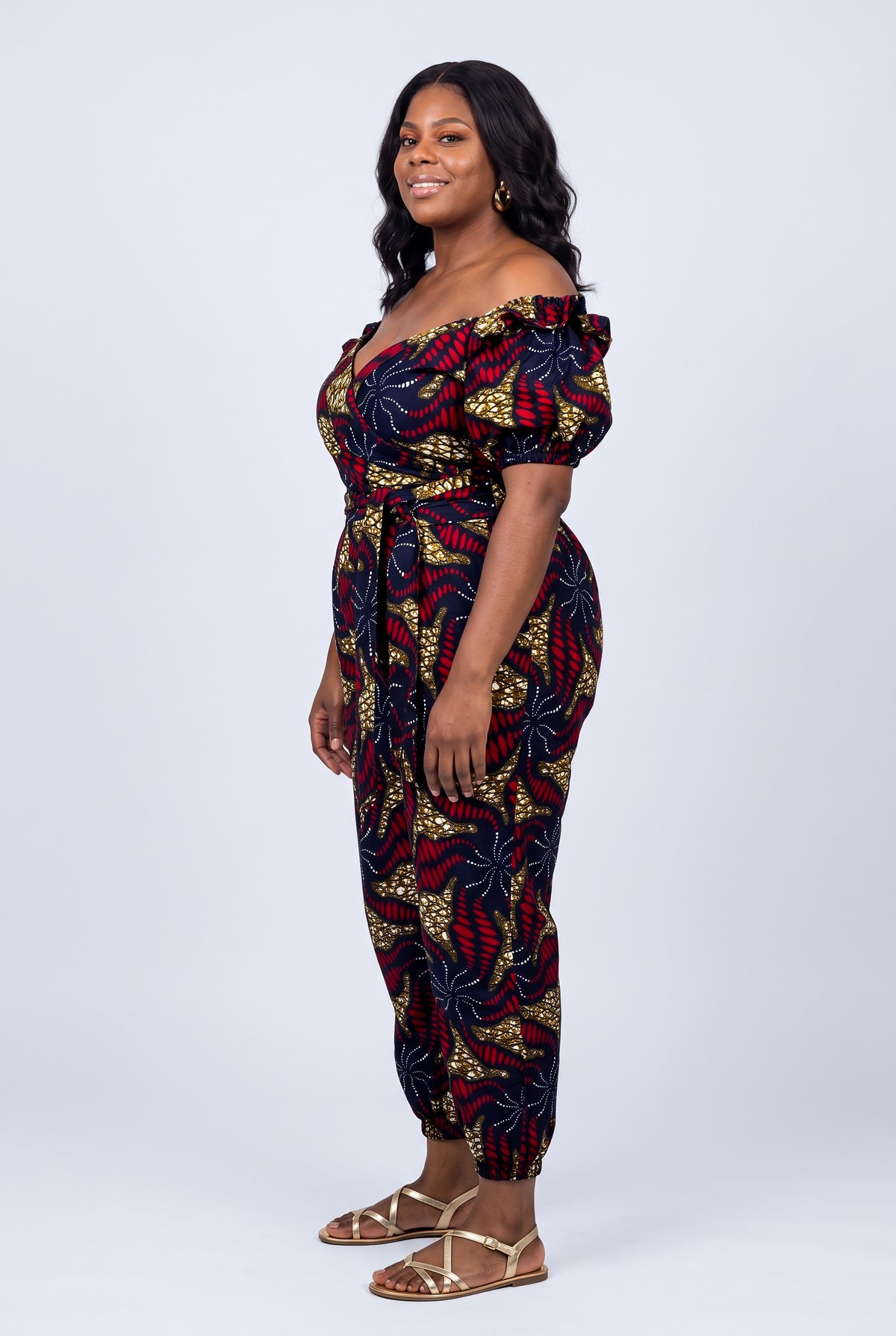 Side view of navy and red Ankara wrap top and trouser set