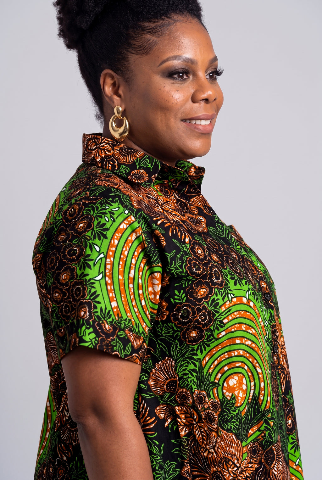 Close up of the green lime and copper botanical geometric Ankara wax print on the Verdant Ripple dress