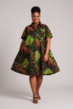 Model walking in Verdant Ripple green Ankara shirt dress with a relaxed flared shape