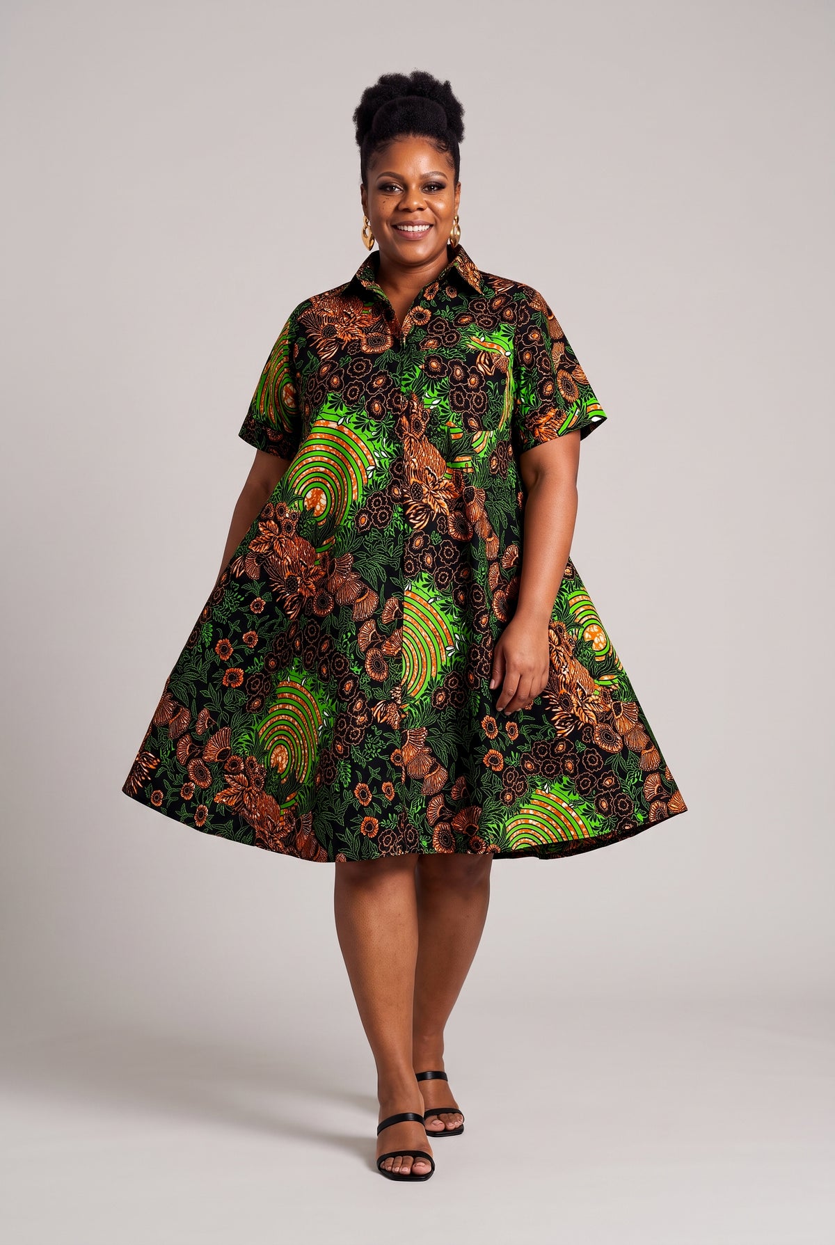 Model walking in Verdant Ripple green Ankara shirt dress with a relaxed flared shape