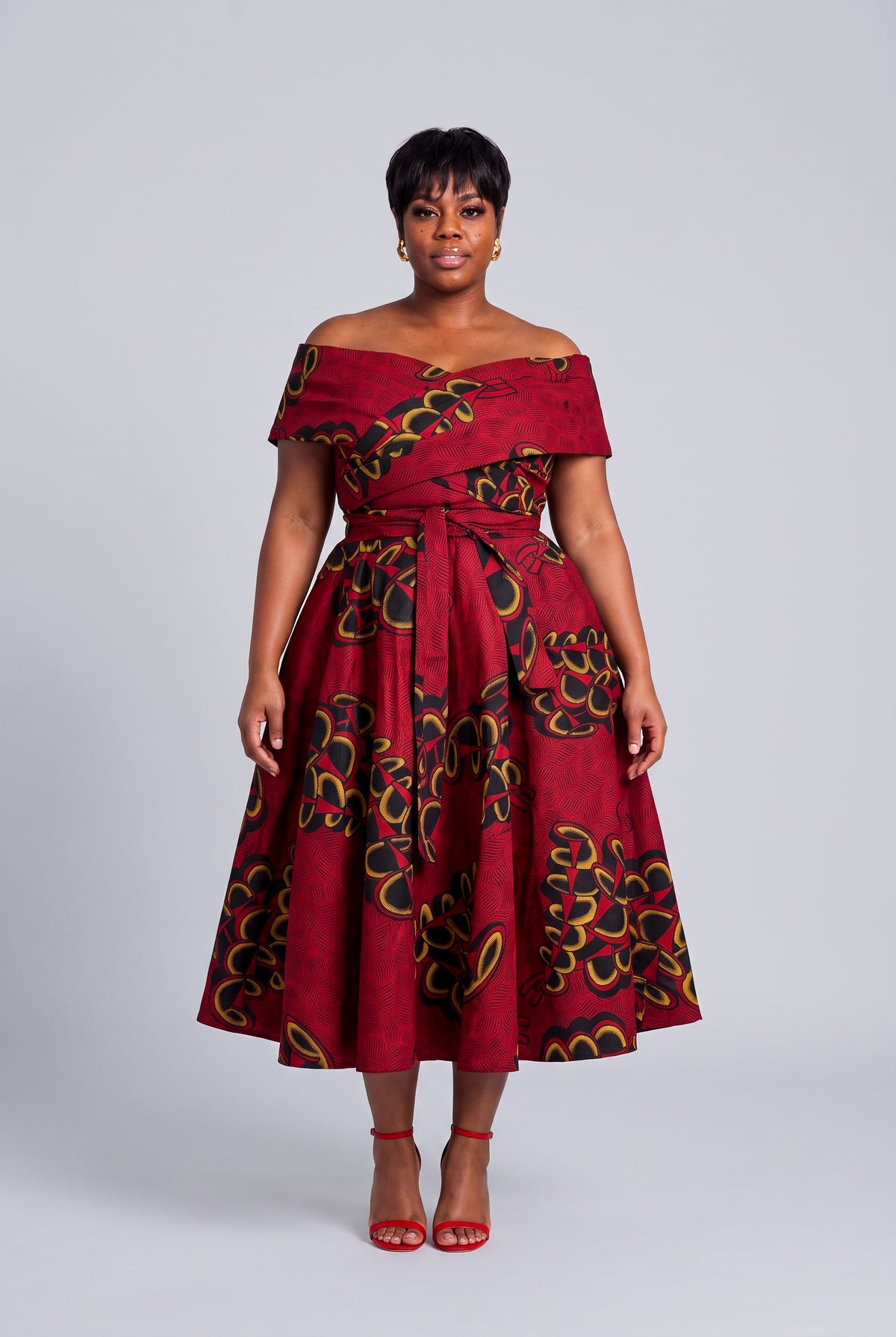 Plus size model wearing Ruby Fan red Ankara wedding guest dress