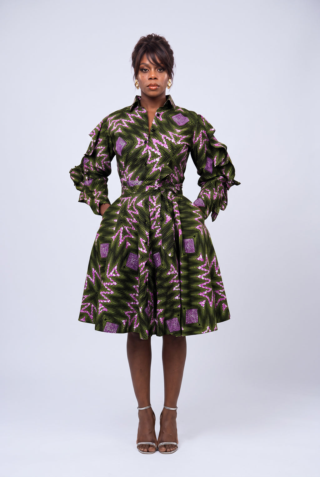 Front view of green, pink and purple Ankara African print shirt dress with ruffle sleeves