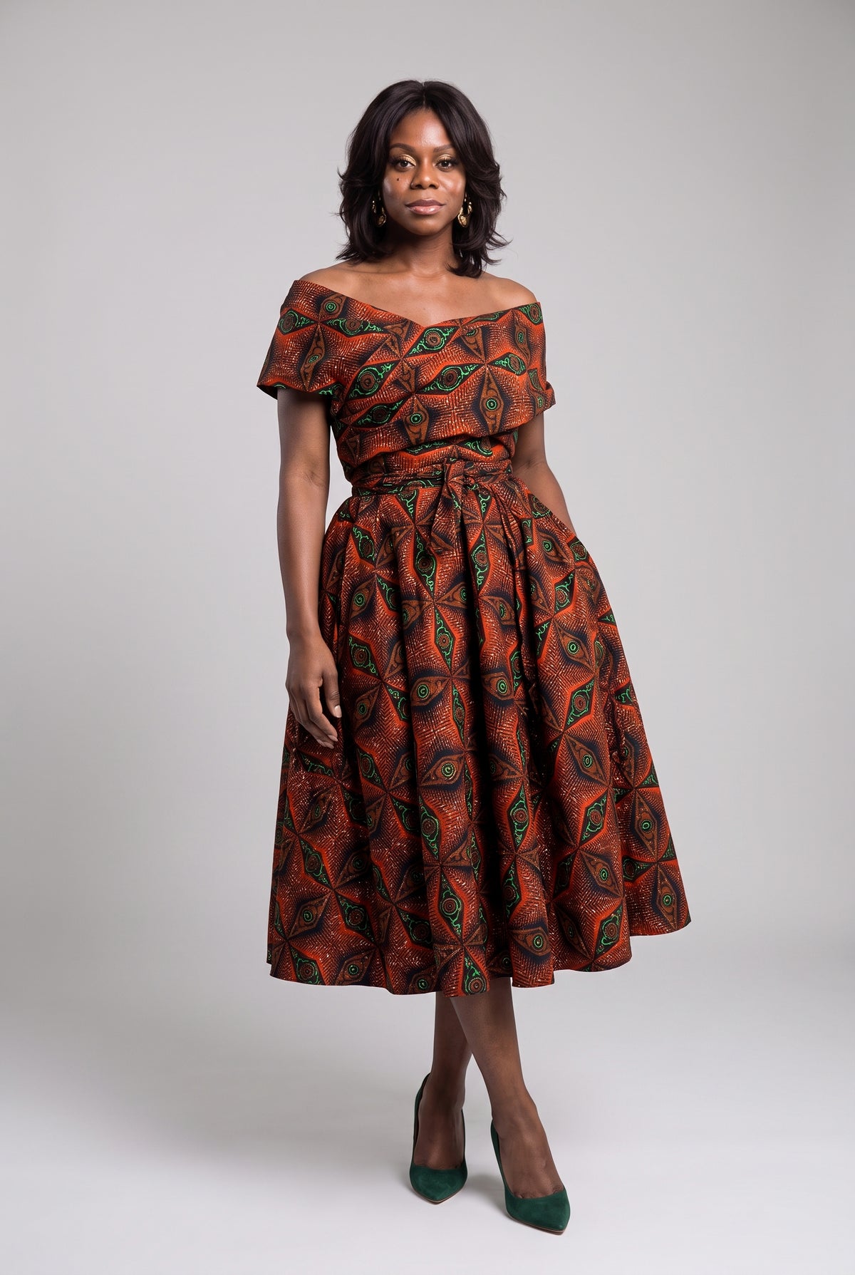 Front view of Copper Star orange African print off shoulder dress