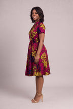 Side view of magenta and gold African wrap dress