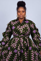Close-up portrait of a model highlighting the classic point collar and button-through detailing  Ankara print shirt dress 