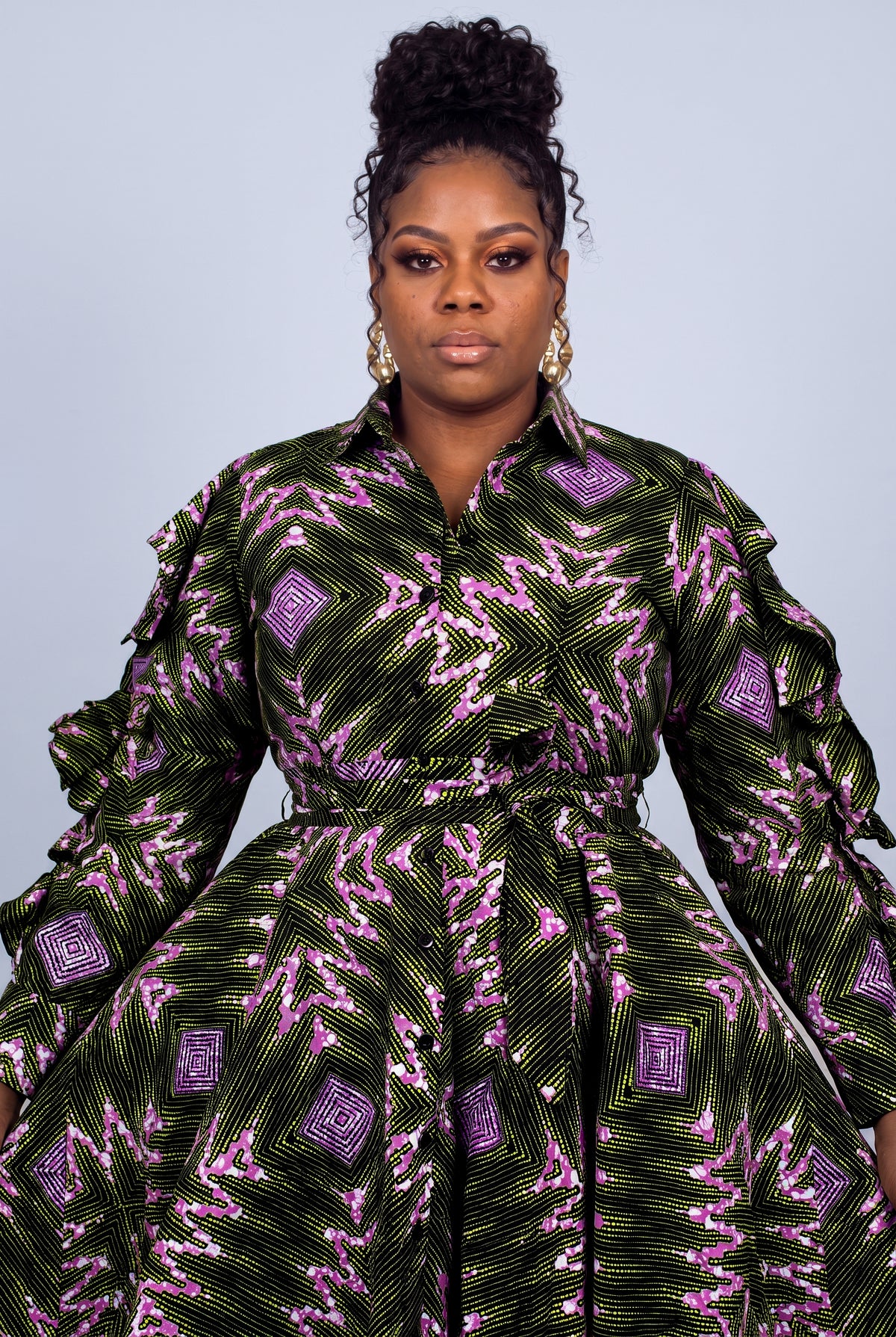 Close-up portrait of a model highlighting the classic point collar and button-through detailing  Ankara print shirt dress 