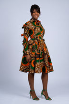 Side view of  studio portrait of a model showing the the long sleeve Ankara shirt dress
