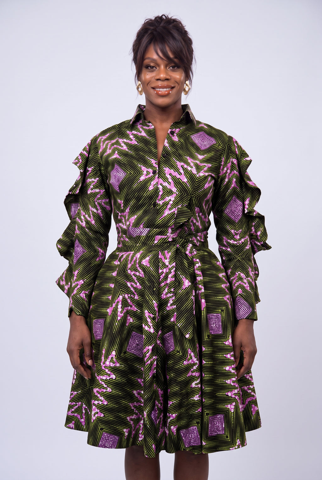 Detail view of green and pink geometric Ankara wax print fabric