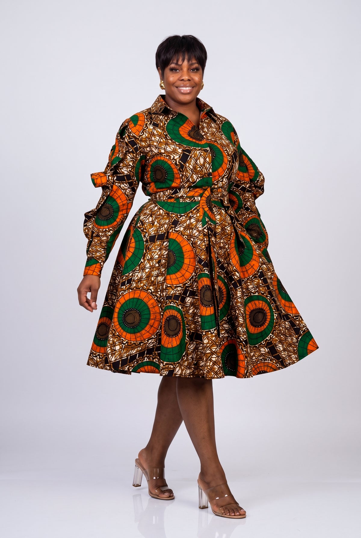 Model walking in Bronze Sun Ankara shirt dress with side pockets